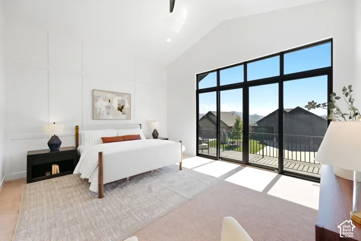 Vaulted ceiling, full-height paneled accent wall, large format black-framed windows, and carpeted flooring