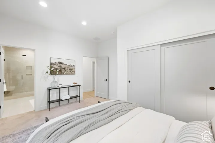 Recessed ceiling lighting, light-toned wall-to-wall carpeting, and white interior doors