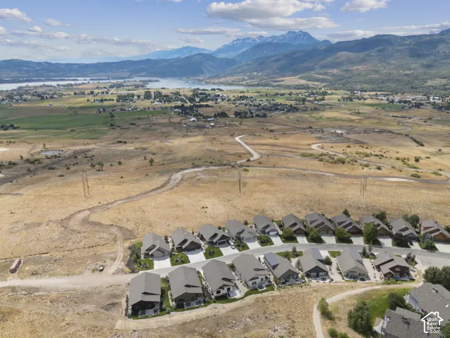 Aerial perspective showcasing a residential development with mountain and lake scenery