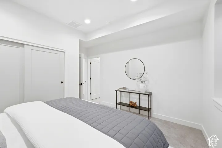 Recessed lighting, light-toned carpeting, white walls, and white trim
