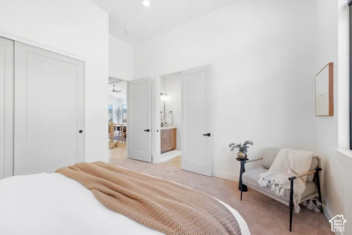 Vaulted ceiling, recessed lighting, white interior doors, window with white trim, and carpeted flooring