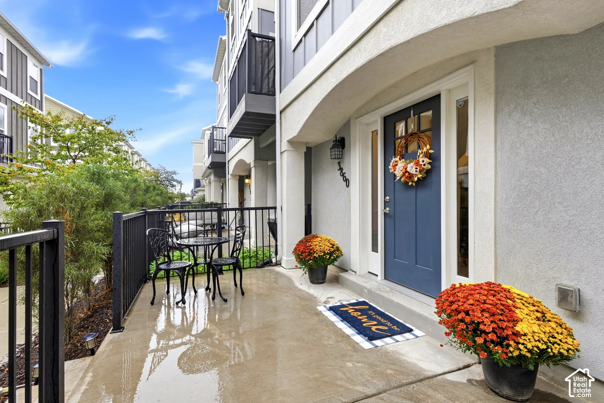Covered entry with a paneled blue door and sidelights