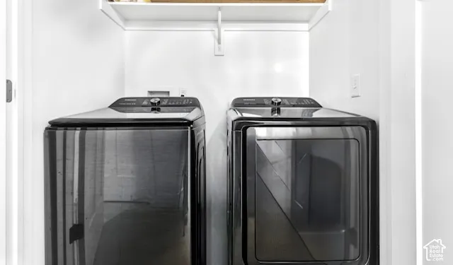 Laundry area featuring a top-load washer, a front-load dryer, and an overhead storage shelf