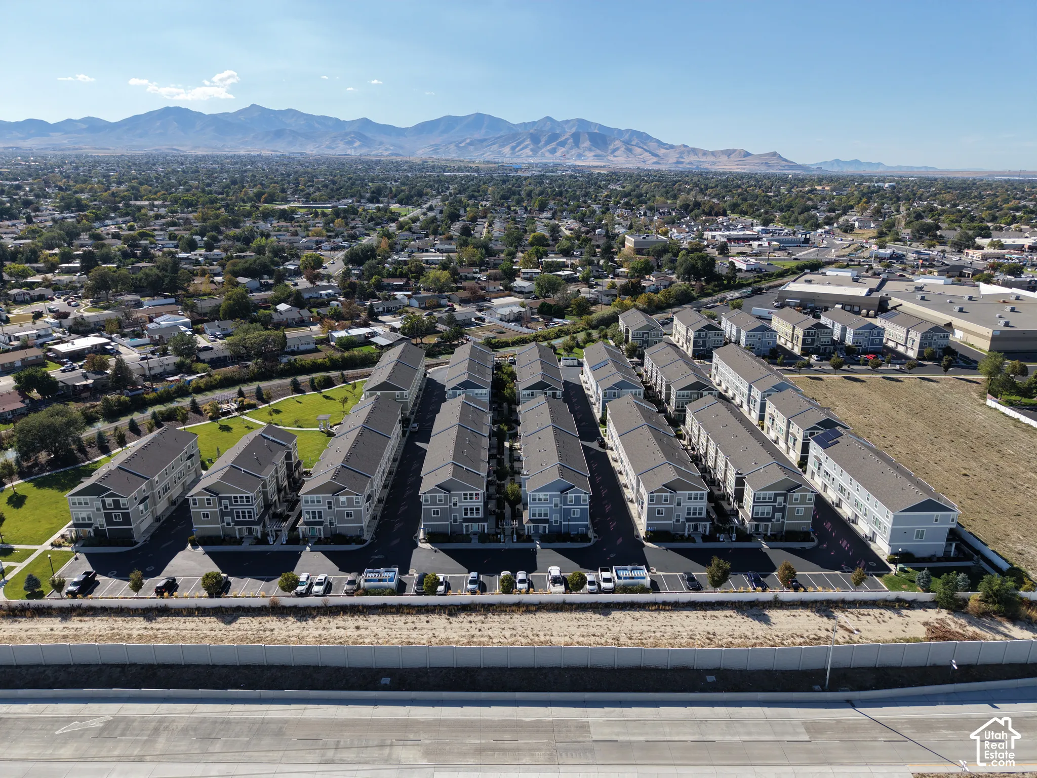 Townhome community featuring multi-story units with pitched roofs and light-toned siding