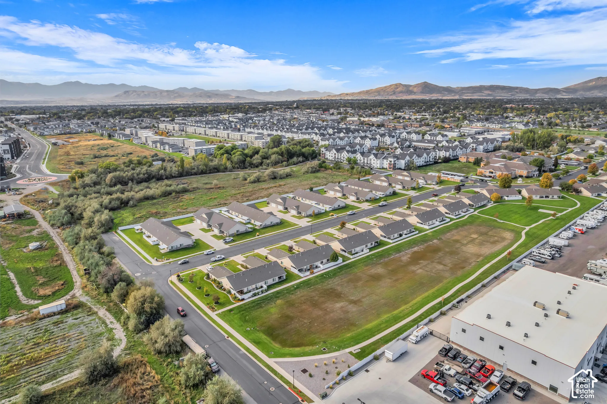 Aerial perspective showcasing a residential community with single-family homes and townhomes