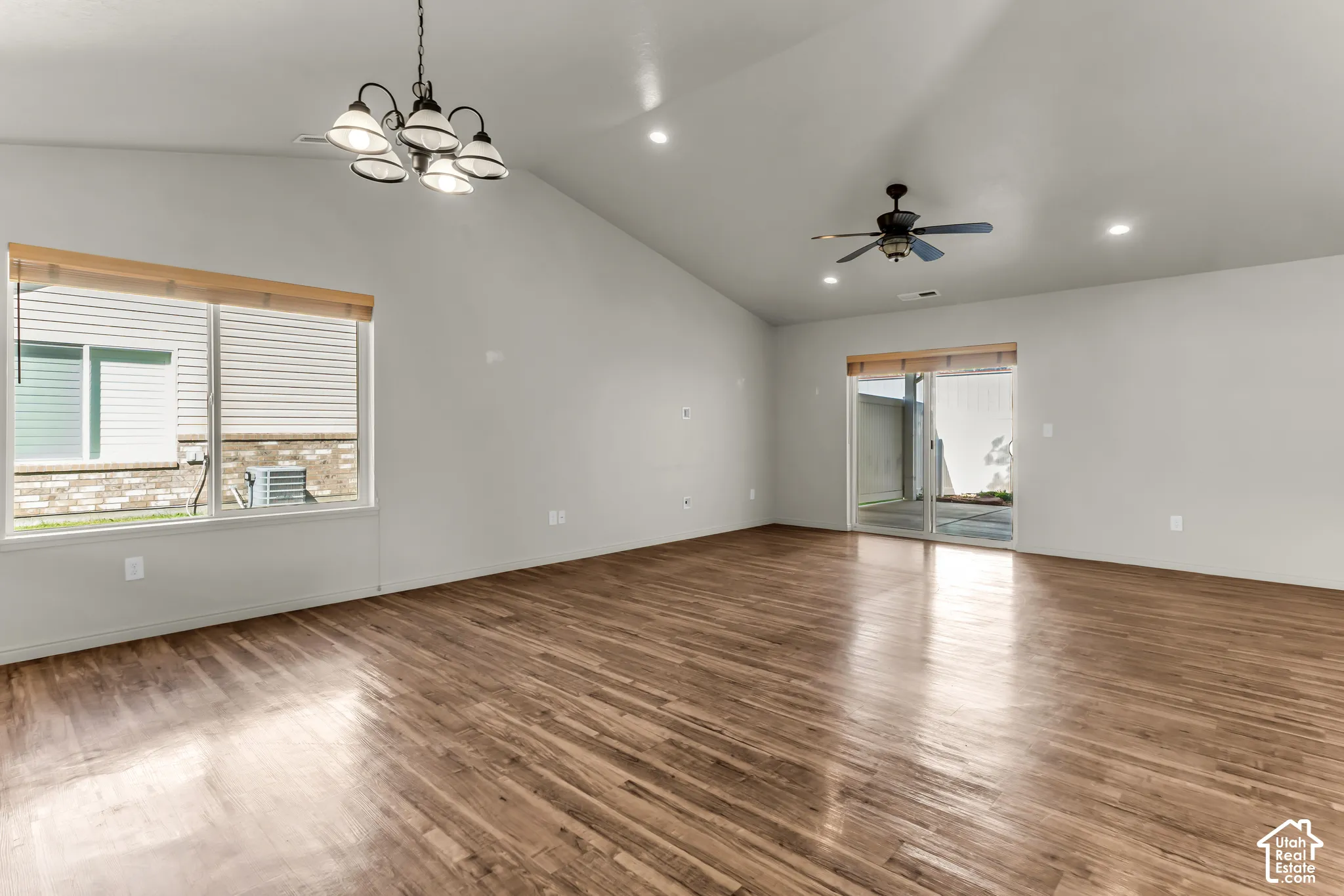 Vaulted ceiling, recessed lighting, wood-finish flooring, ceiling fan, sliding glass door