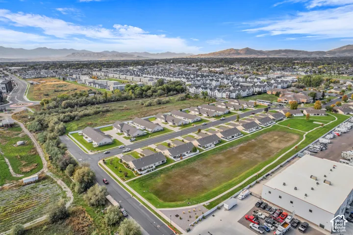 Aerial perspective showcasing a residential community with single-family homes and townhomes