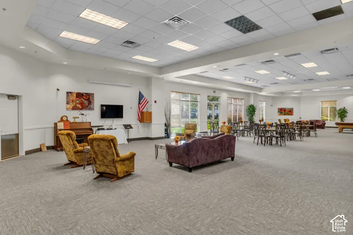 Spacious common area featuring patterned carpeting and recessed lighting