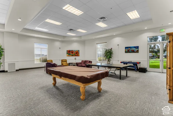 Spacious room with large windows, recessed lighting, and drop ceiling
