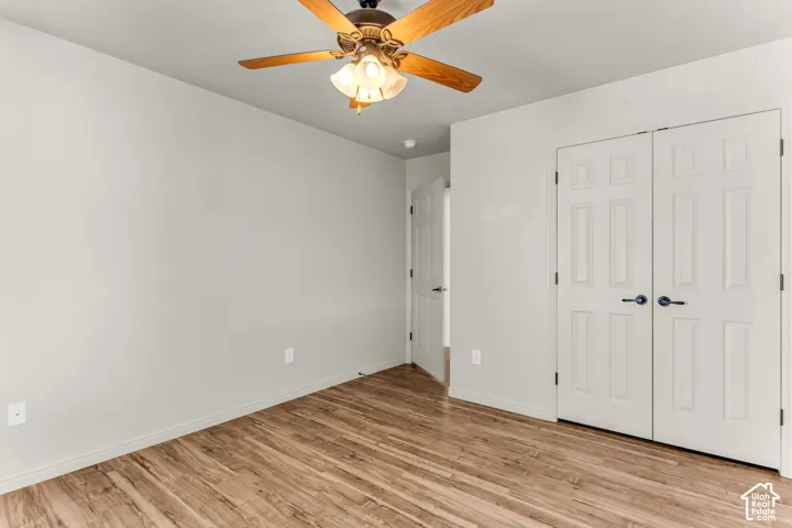 Wood-finish flooring with a ceiling fan light fixture