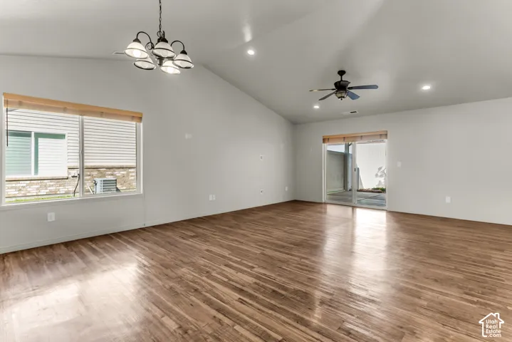 Vaulted ceiling, recessed lighting, wood-finish flooring, ceiling fan, sliding glass door