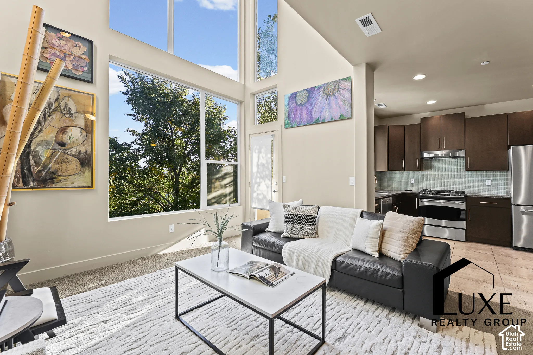 Vaulted ceilings and expansive windows create a bright living area