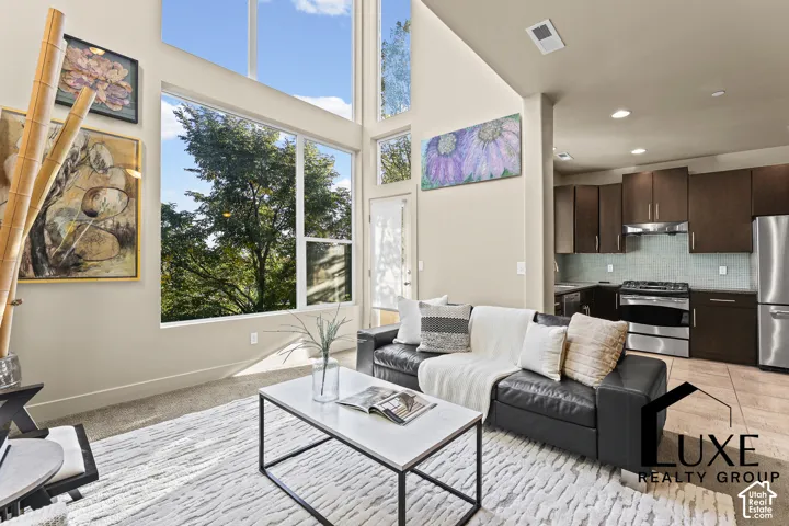 Vaulted ceilings and expansive windows create a bright living area
