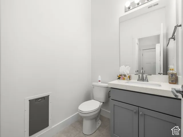 Modern vanity with a light-colored countertop, undermount sink, and chrome faucet