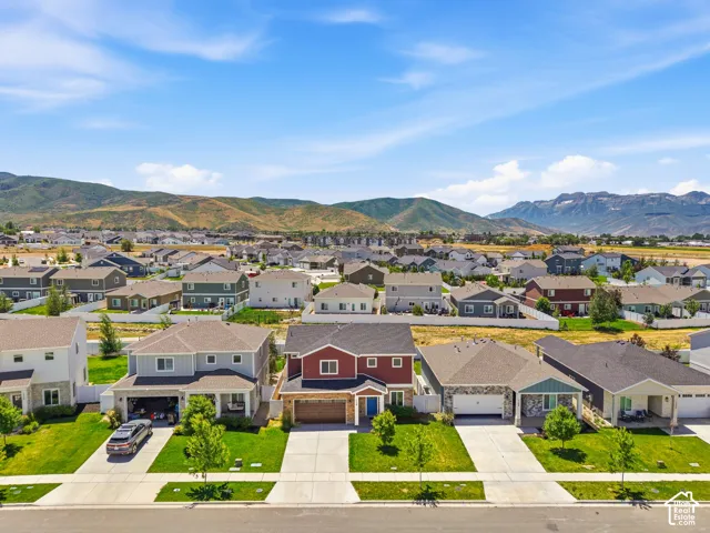 Residential neighborhood with a mountain backdrop, featuring a variety of housing styles