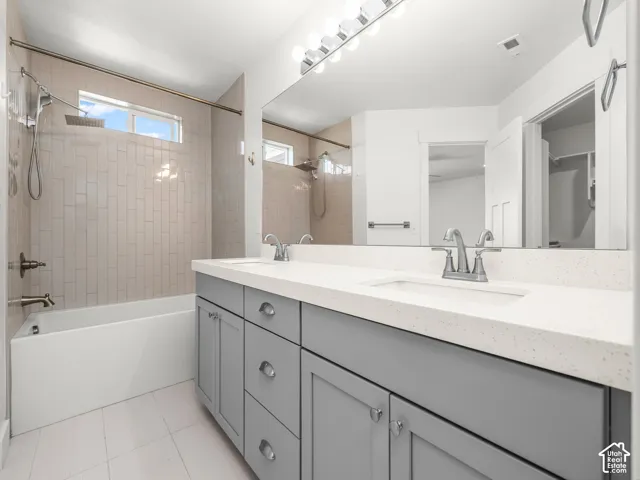 Dual vanity with quartz countertop, undermount sinks, and contemporary gray cabinetry