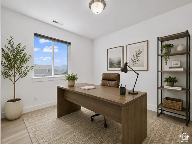 Recessed lighting, wood-finish flooring, and a large window with a modern blind