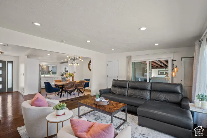 Recessed lighting illuminates the living area with wood-finish flooring