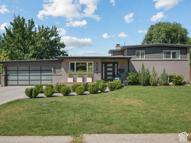 Contemporary brick and siding exterior with a flat roofline