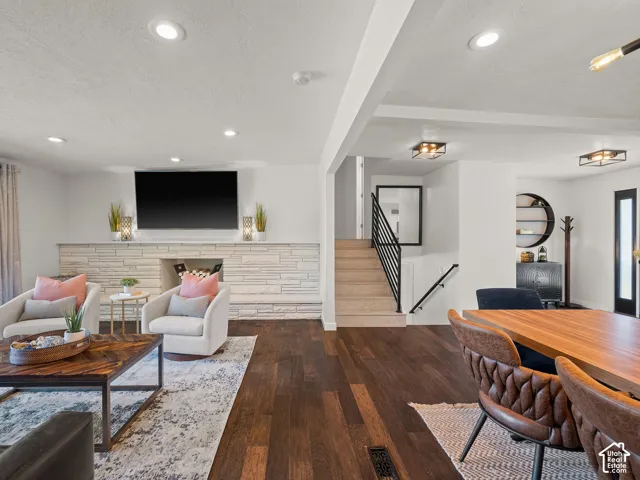 Rich wood-finish flooring throughout, complemented by a stone-clad fireplace