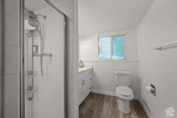 Walk-in shower with clear glass enclosure and white subway tile surround