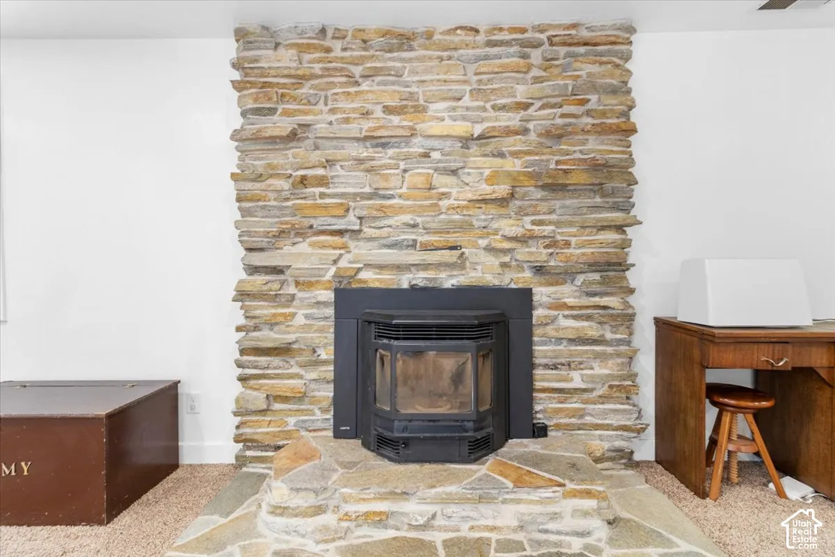 Stacked stone pellet wood fireplace with a black insert