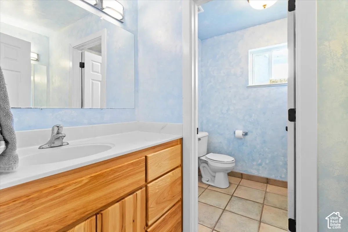Wood-finish vanity with an integrated sink and chrome faucet