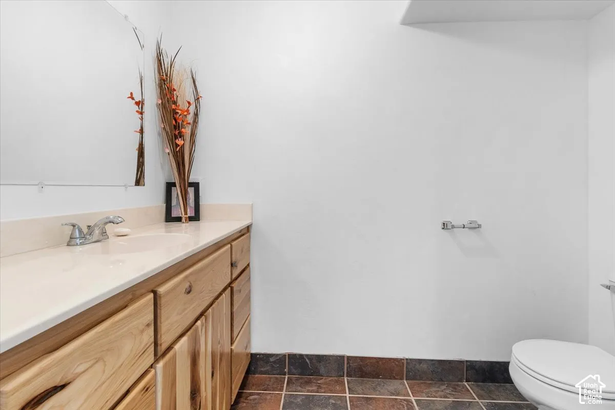 Wood-finish vanity with an integrated sink and light-toned countertop