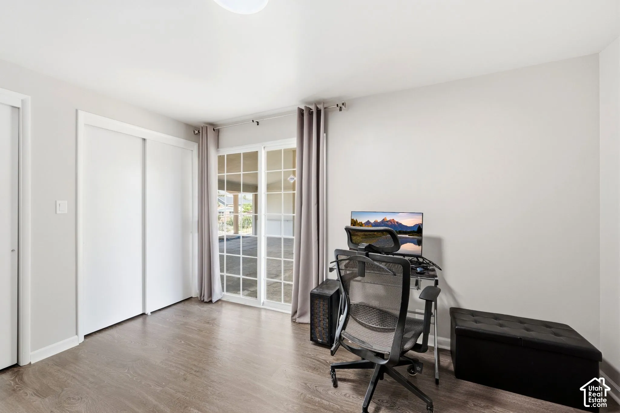 Light wood-finish flooring with white walls