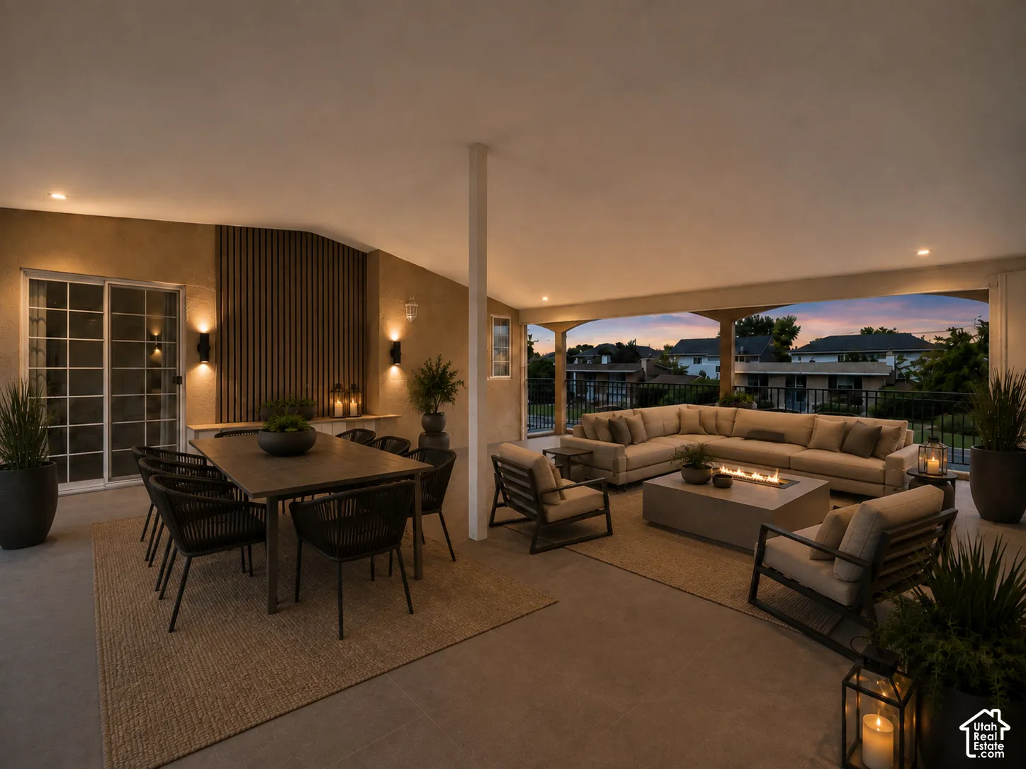Expansive covered patio featuring a large dining area, comfortable seating arrangement, and a built-in fire feature