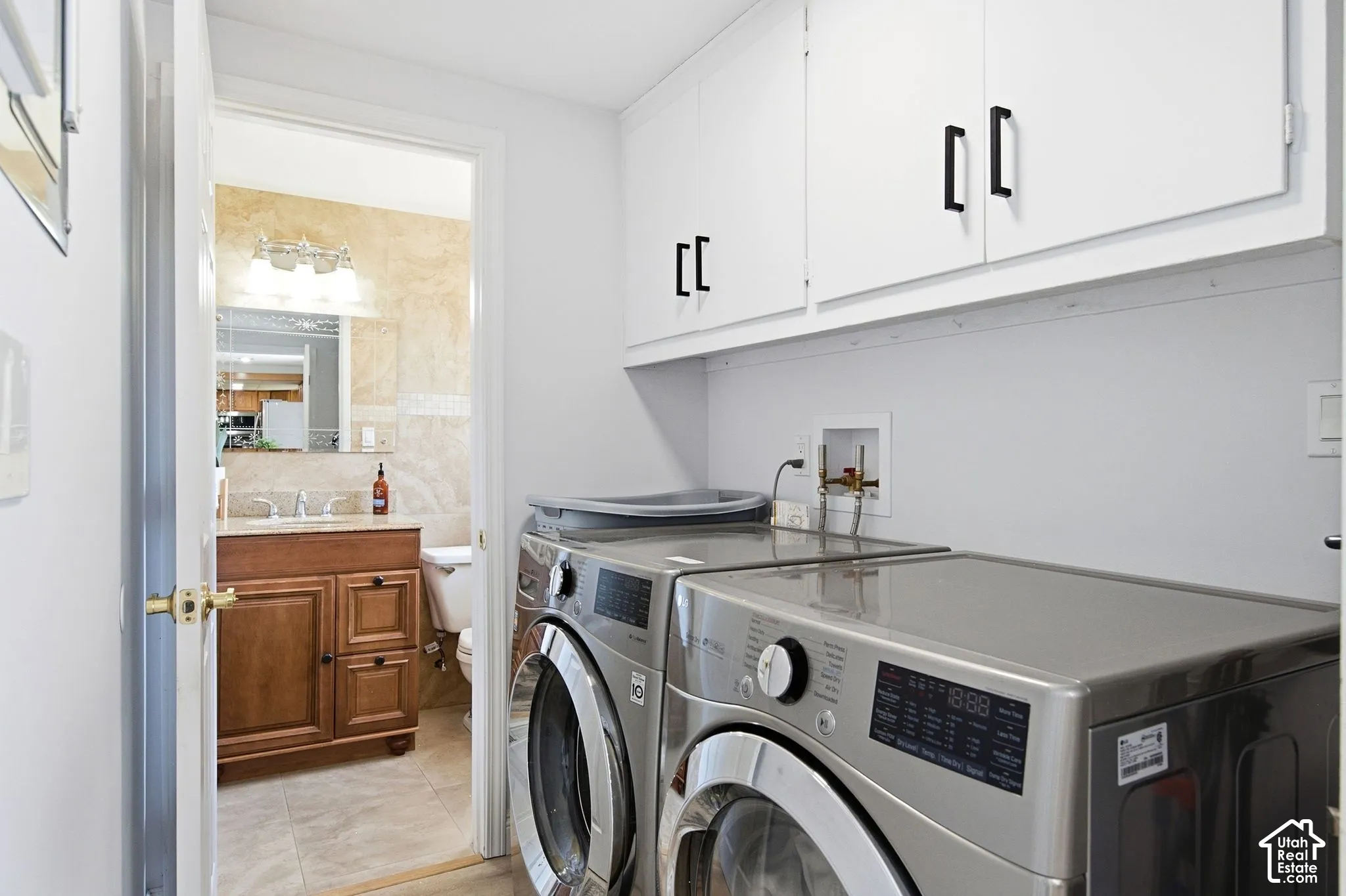 White upper cabinetry with black hardware