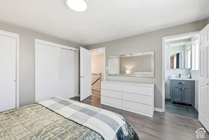 Recessed ceiling lighting, wood-finish flooring, and white bi-fold closet doors