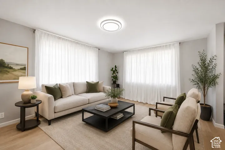 Hardwood-finish flooring, light grey wall paint, and recessed ceiling lighting