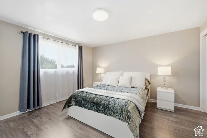 Neutral tone wall paint, wood-finish flooring, and a flush mount ceiling light fixture