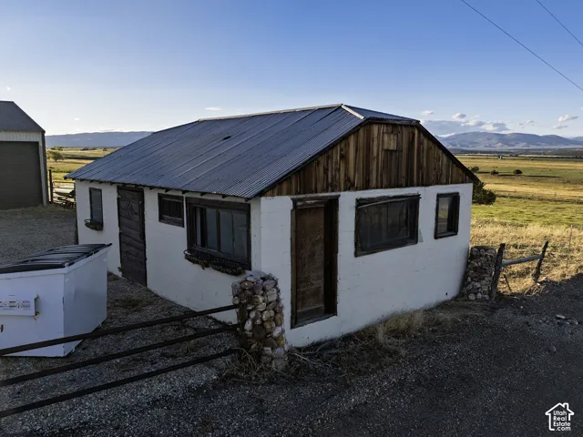 White-painted exterior structure with a metal roof