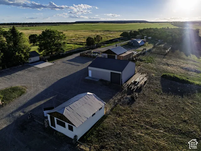 Expansive gravel parking area with multiple outbuildings