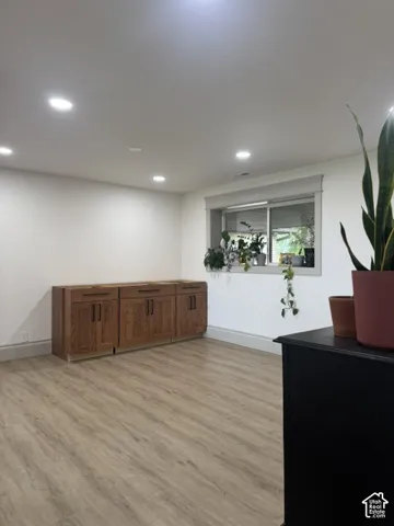 Recessed ceiling lighting illuminating wood-finish flooring