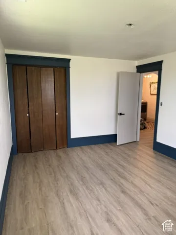 Wood-finish flooring throughout, complemented by dark baseboards and door trim