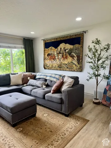 Recessed ceiling lighting, wood-finish flooring, and expansive windows