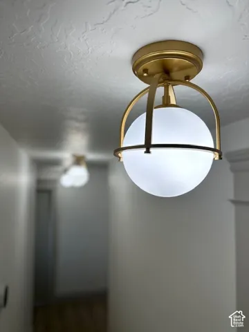 Modern flush mount light fixture with a gold-tone finish and frosted globe