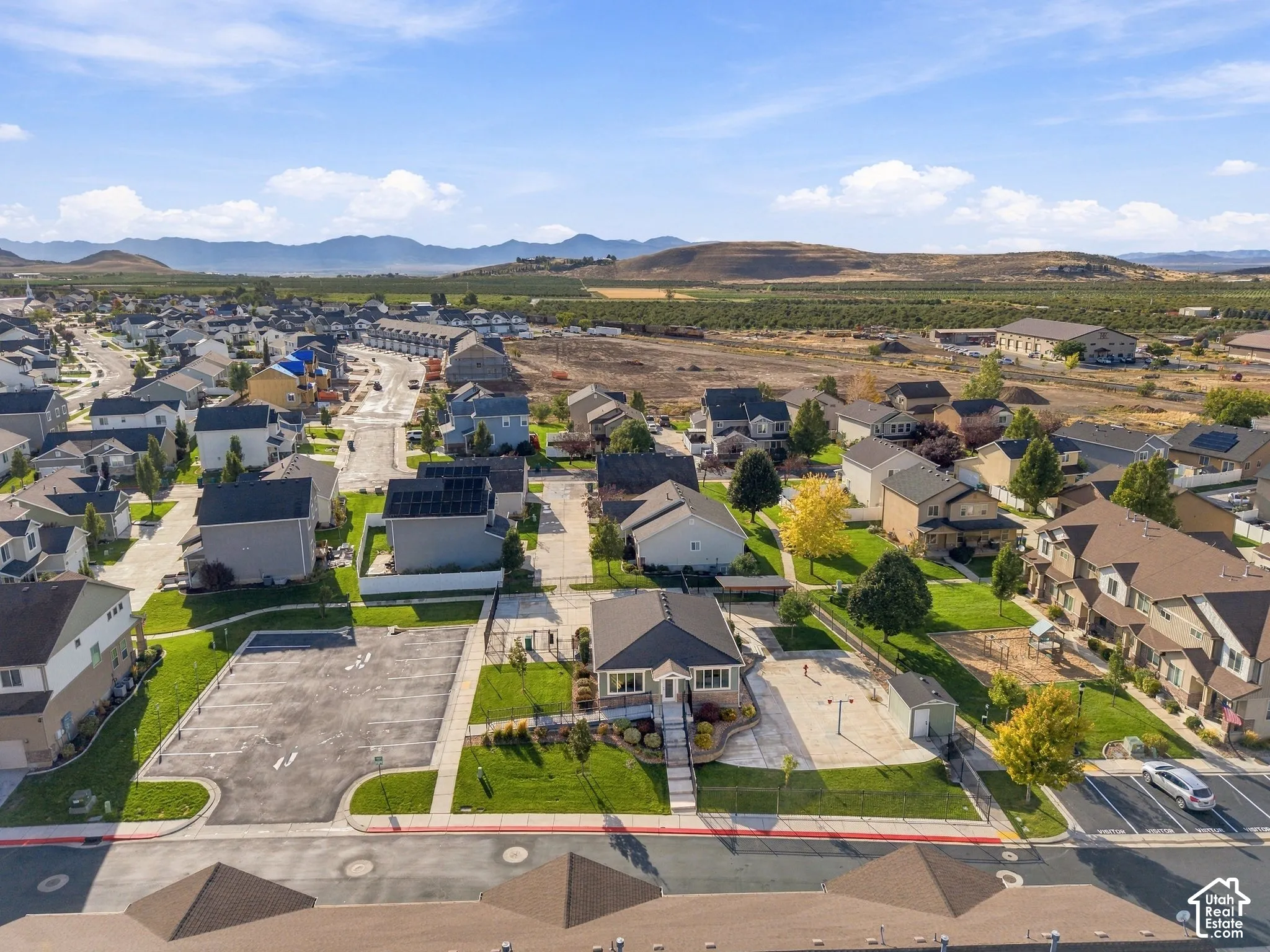 Residential community with mountain backdrop, established landscaping, and varied rooflines