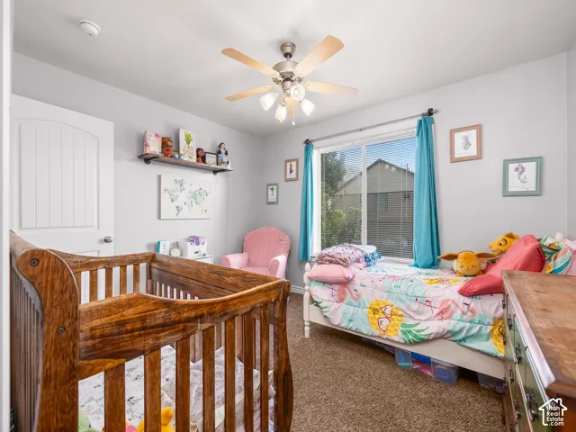 Wall-to-wall carpeting, overhead ceiling fan with light, and a window with blinds