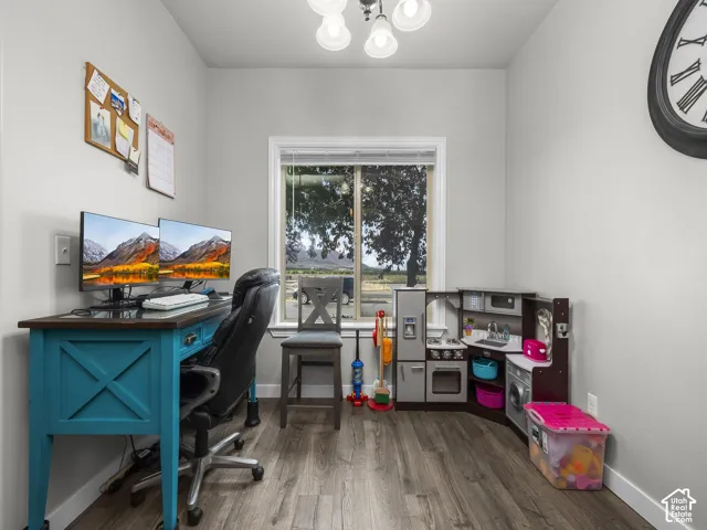 Neutral gray walls with wood-finish flooring and a single window offering natural light