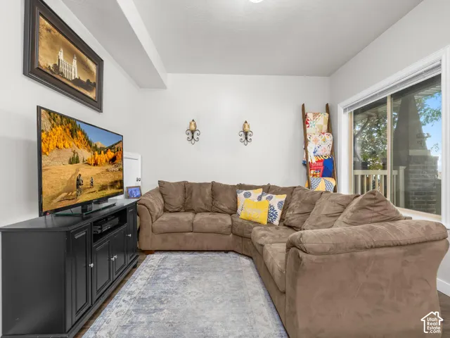 Wood-finish flooring, white walls, and a large window