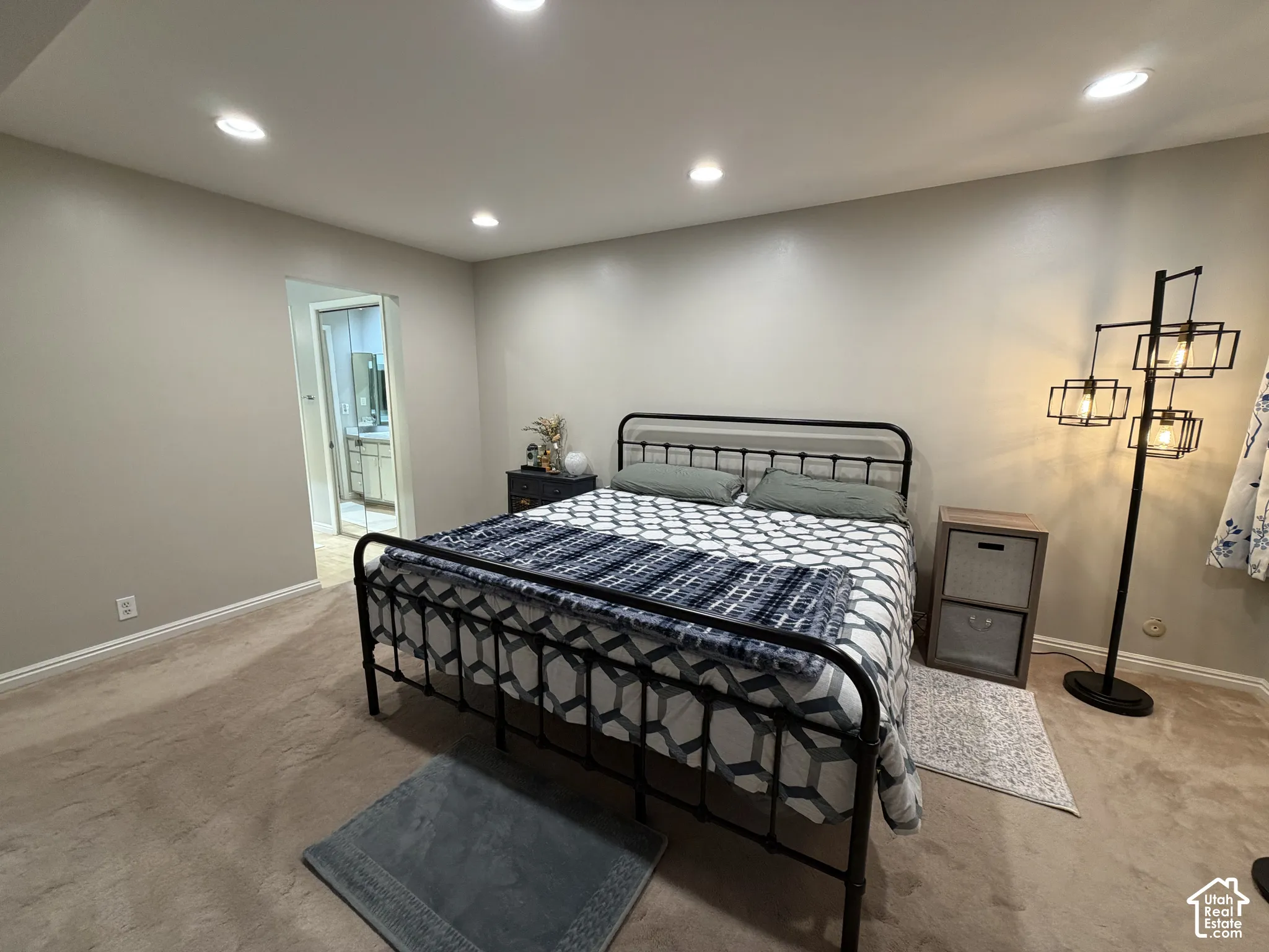 Recessed ceiling lighting, light neutral wall paint, and plush carpeting