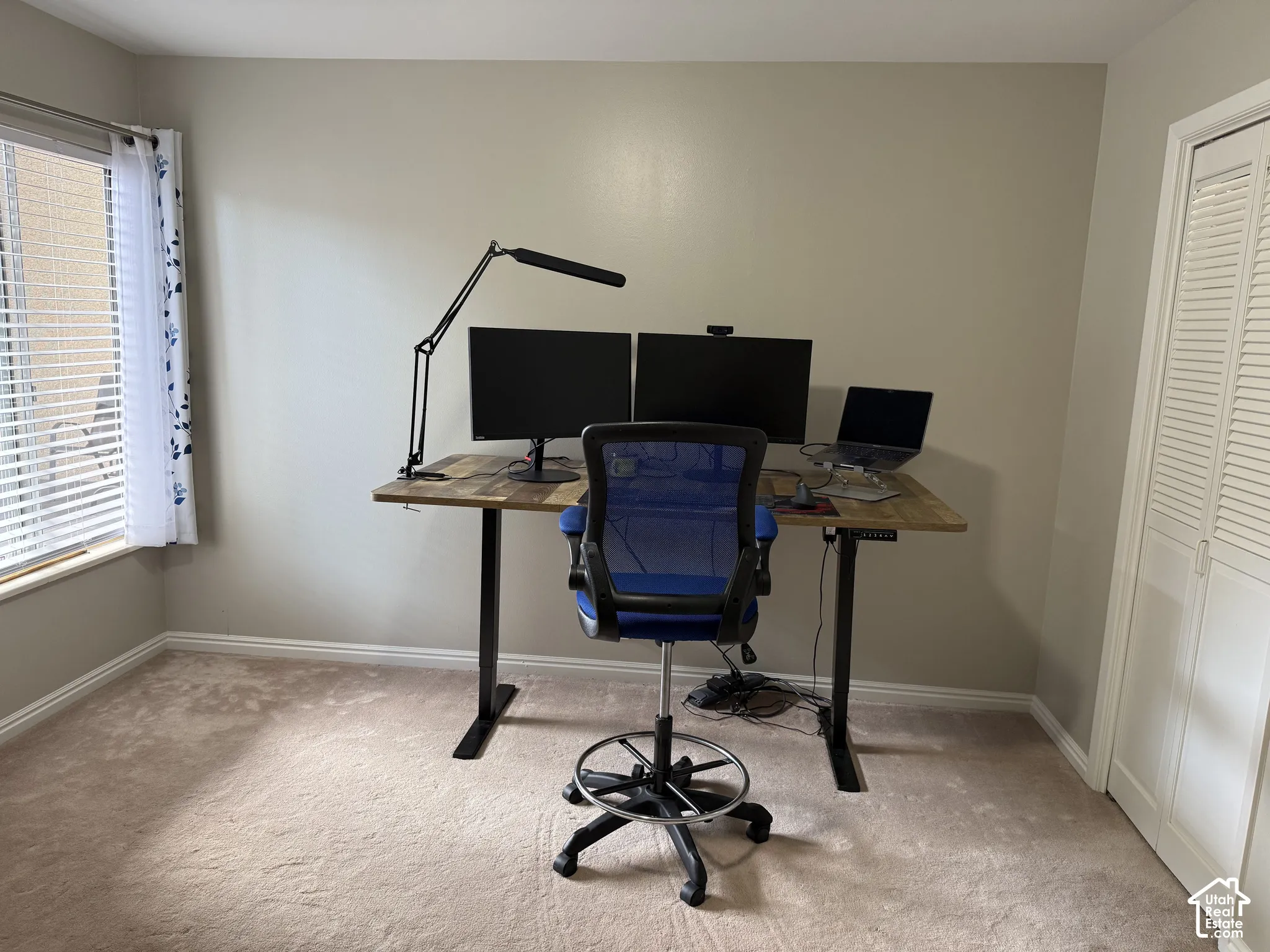 Neutral-toned walls complement plush carpeting