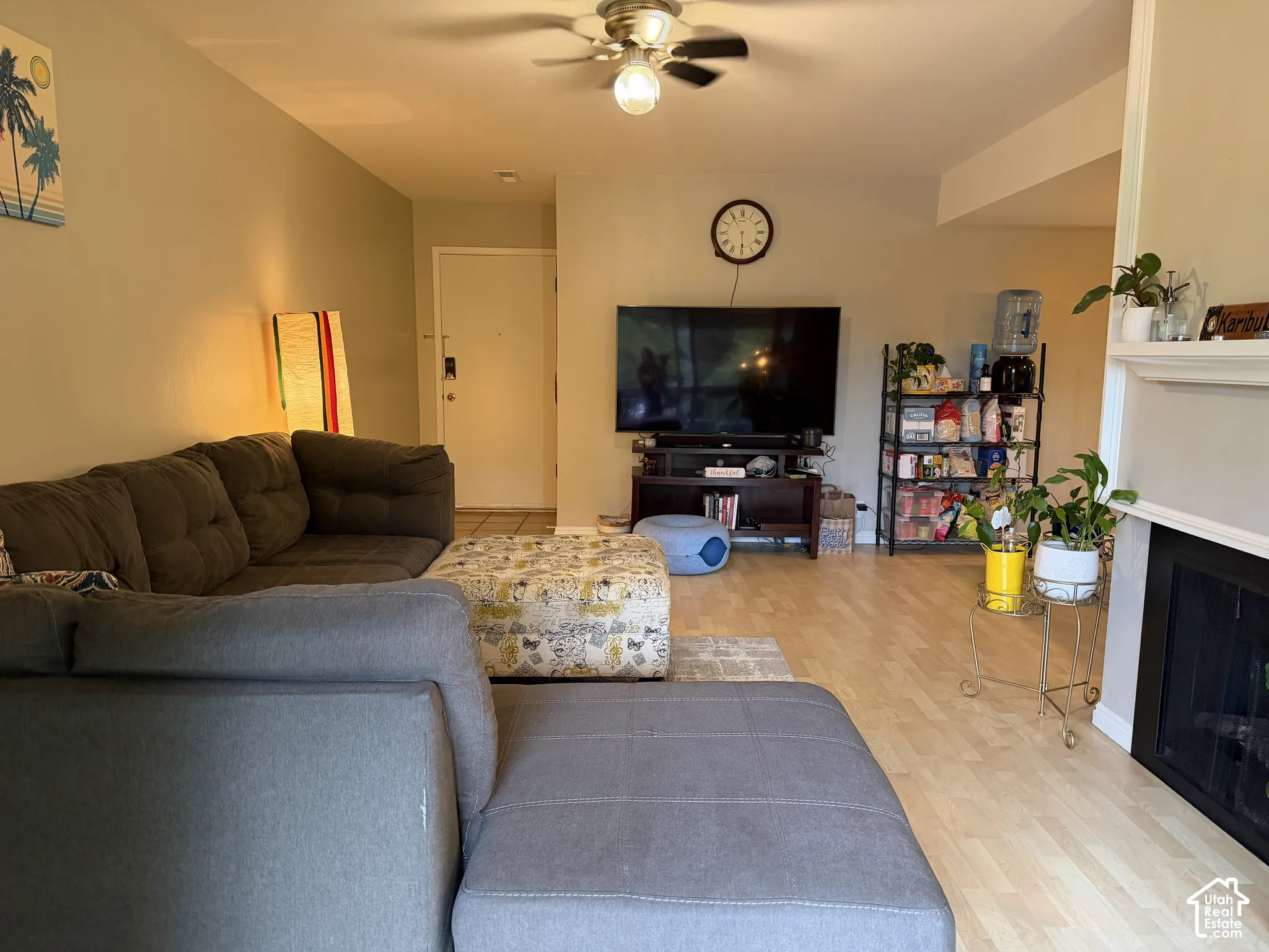 Wood-finish flooring throughout, complemented by a ceiling fan with integrated lighting