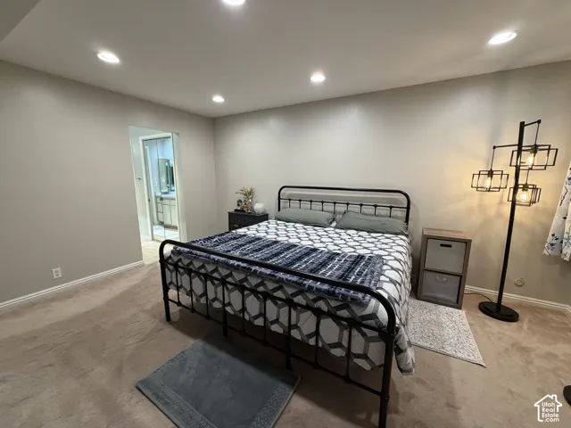 Recessed ceiling lighting, light neutral wall paint, and plush carpeting
