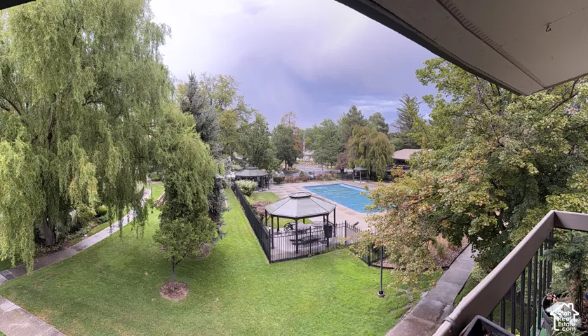 Expansive outdoor space featuring a swimming pool, multiple gazebos, and mature landscaping