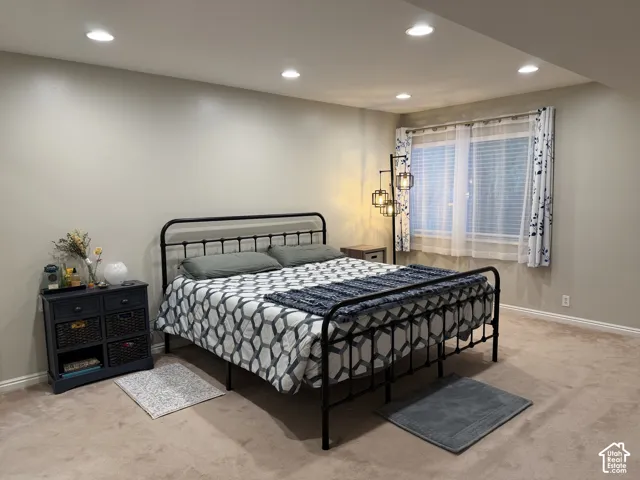 Recessed ceiling lighting, wall-to-wall carpeting, and baseboard trim